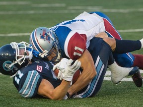 Alouettes linebacker Chip Cox brings down Argonauts wide receiver Devon Wylie during the first quarter of their pre-season game in Montreal on Friday night. (THE CANADIAN PRESS/PHOTO)