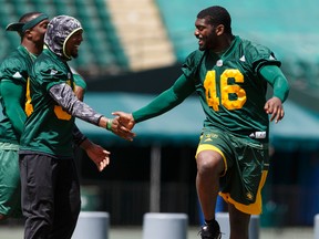 Eskimos Garry Peters (left) and Jimmy Gaines celebrate during a team building exercise at an Edmonton Eskimos walkthrough at Commonwealth Stadium in Edmonton on June 17, 2016. The CFL team plays a pre-season home game on Saturday versus the Saskatchewan Roughriders.