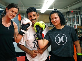 Sheena Kaine (left) and her daughter Alexis Flamand (right) with their boxing coach John Mendonca (middle) at Alliance Boxing Club in Edmonton.