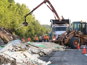 John Lappa/Sudbury Star
Lumber is cleared off of Highway 17 East near Whitefish after a transport spilled its load on Friday. Police have not released any details of the accident.