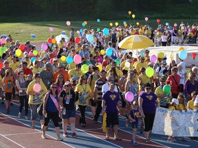 John Lappa/Sudbury Star Participants take part in the survivors lap at the Canadian Cancer Society Relay for Life event at the track at Laurentian University in Sudbury on Friday. The fundraiser raises money for research and community support services.