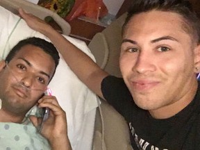 FILE - In this June 13, 2016 file photo released by Joseph Rivera, Felipe Marrero, left, poses in his hospital bed in Orlando, Fla., in this image taken by his friend Joseph Rivera, right. Marrero was shot four times in his back and left arm during last Sunday's attack on an Orlando nightclub. (Joseph Rivera via AP, File)