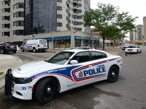 London Police vehicles close down Mill Street in London, Ontario where the body of a baby was found in a dumpster on Thursday June 16, 2016. 
(MORRIS LAMONT  / THE LONDON FREE PRESS / POSTMEDIA NETWORK)