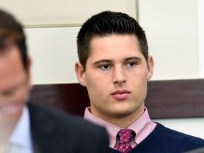 Brandon Vandenburg, right, a former Vanderbilt football player, waits in court for proceedings to begin in his rape trial Tuesday, June 14, 2016, in Nashville, Tenn. A jury convicted Vandenburg and former player Corey Batey last year after a trial that featured graphic cellphone videos and photos of the attack taken by the former players. However, the verdicts were thrown out after it was discovered that the jury foreman had been a victim of statutory rape. (Samuel M. Simpkins/The Tennessean via AP, Pool)