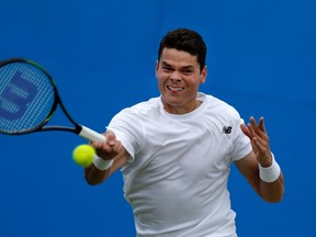 Canada’s Milos Raonic returns to Australia’s Bernard Tomic during their semifinal in the ATP Aegon Championships at the Queen’s Club in west London on June 18, 2016. (AFP PHOTO/ADRIAN DENNIS)