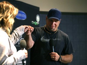 Garth Brooks and Trisha Yearwood fist-bump during a press conference for the Garth Brooks World Tour, in the Director's Lounge at MTS Centre in Winnipeg on Sat., June 18, 2016. (Kevin King/Winnipeg Sun/Postmedia Network)