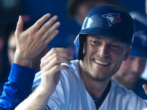 Toronto Blue Jays left fielder Michael Saunders celebrates in the dugout after scoring against the Baltimore Orioles in Toronto on Thursday June 9, 2016. (THE CANADIAN PRESS/Chris Young)