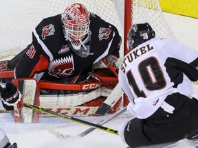 Calgary Hitmen Jakob Stukel is stopped by Moose Jaw Warriors goalie Zach Sawchenko in WHL action at the Scotiabank Saddledome in Calgary on Jan. 22, 2016. (Mike Drew/Calgary Sun/Postmedia Network)