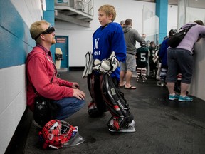 Shawn Brown chats with his son Hunter, 9, during a break between games at the Nepean Sportsplex.