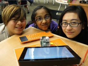 Neeysa Cruz, 10, Sudiksha Singhal, 11, and Kirsten Kwong, 20 made a miniature computer camera at the Rasberry Jam Youth Workshop in the downtown Edmonton library June 18, 2016.