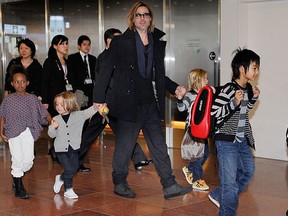FILE - Accompanied by their six children, Brad Pitt and Angellina Jolie appear before photographers upon their arrival at Haneda Airport in Tokyo on November 8, 2011. (TORU YAMANAKA/AFP/Getty Images)
