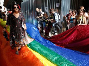 People gather to protest against the ban on the gay pride march, off Istiklal Avenue, central Istanbul's main shopping road, Sunday, June 19, 2016. Turkish police fired tear gas and rubber bullets to disperse demonstrators who gathered for a gay pride rally in Istanbul despite a government ban over security concerns. (AP Photo/ Emrah Gurel)