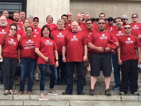 Unifor members stand outside the Manitoba legislature after protesting the secret-ballot requirement for union certification votes on June 15, 2015. (Winnipeg Sun Files)