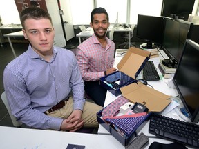 Business development director Jack Curtis, left, and company founder Kishwaar Hashmee display the boxes of their men?s fashion accessories shipped to customers who have a subscription with their Club Evoq. (MORRIS LAMONT, The London Free Press)
