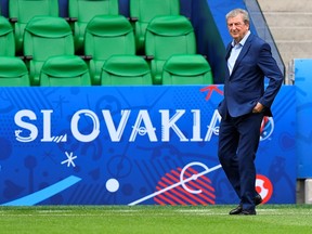 England's head coach Roy Hodgson checks a pitch on the eve of their match against Slovakia in Saint Etienne on June 19, 2016, during the the Euro 2016 football tournament. (AFP PHOTO/JOE KLAMAR)