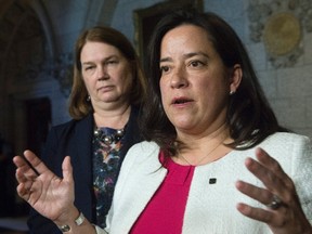Minister of Health Jane Philpott looks on as Minister of Justice and Attorney General of Canada Jody Wilson-Raybould responds to a question from the media in the Foyer of the House of Commons on Parliament Hill on June 16, 2016 in Ottawa. THE CANADIAN PRESS/Adrian Wyld