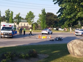 A motorcyclist's body is seen covered with a tarp after a collision with a Peel Regional Police cruiser near Tomken and Derry Rds. in Mississauga Sunday, June 19, 2016. (Pascal Marchand/Special to the Toronto Sun)