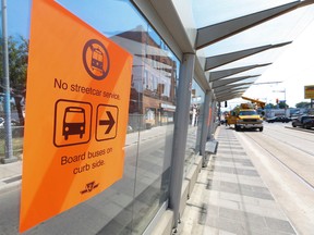 Signage is put up as TTC shuts down the St. Clair Ave. W. streetcar tracks Sunday June 19, 2016. (Jack Boland/Toronto Sun)