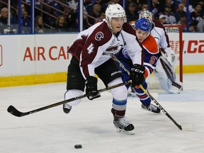 Tyson Barrie fights off Oilers centre Connor McDavid during a game last season. (Reuters)
