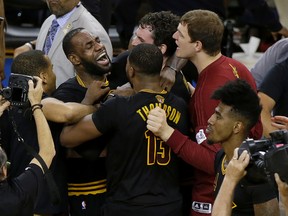 Cleveland Cavaliers forward LeBron James, top left, celebrates with teammates after Game 7 of basketball's NBA Finals against the Golden State Warriors in Oakland, Calif., Sunday, June 19, 2016. The Cavaliers won 93-89. (AP Photo/Eric Risberg)