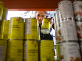 A volunteer stocks shelves at the Wood Buffalo Food Bank, in Fort McMurray on Friday June 17, 2016.