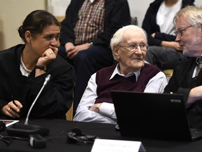 94-year-old former SS sergeant Oskar Groening sits between his lawyers Hans Holtermann, right, and Susanne Frangenberg, left, during the verdict of his trial Wednesday, July 15, 2015 at a court in Lueneburg, northern Germany. Groening, who served at the Auschwitz death camp was convicted on 300,000 counts of accessory to murder and given a four-year sentence. (Tobias Schwarz/Pool Photo via AP)