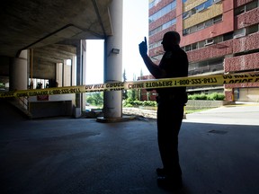 Police continue to investigate a suspicious death outside the Chateau Lacombe Hotel, 10111 Bellamy Hill Road, parkade in downtown Edmonton, in Edmonton Alta. on Monday June 20, 2016. Photo by David Bloom