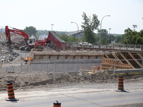 Jason Miller/The Intelligencer
Construction crews work away at completing the south abutment where the new bridge will sit connecting Bay Bridge Road to Dundas Street West.