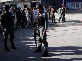 Afghan police soldiers inspect the site of a suicide attack in Kabul, Afghanistan, Monday, June 20, 2016.  (AP Photo/Rahmat Gul)
