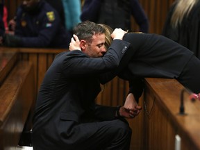 Oscar Pistorius, hugs his sister Aimee, right, in the High Court in Pretoria, South Africa, Wednesday, June 15, 2016 on the third day of the double-amputee runner's sentencing hearing for murdering girlfriend Reeva Steenkamp. (Alon Skuy, Pool via AP)
