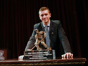 In this phtoo provided by the Hobey Baker Memorial Award Foundation, Harvard senior forward Jimmy Vesey poses for a photo with the 2016 Hobey Baker Award on Friday, April 8, 2016, in Tampa, Fla.  (Brian Blanco/ Hobey Baker Memorial Award Foundation via AP)