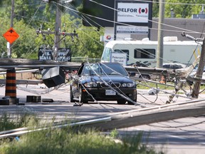 Eight hydro poles came down along John Counter Boulevard between Portsmouth Avenue and Sir John A Macdonald Boulevard at approximately noon in Kingston in June. (Steph Crosier/The Whig-Standard)