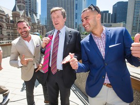 Toronto Mayor John Tory poses with the pink tie he received from Mathieu Chantelois (left), Pride Toronto executive director, and Aaron GlynWilliams, Pride Toronto co-chair, at the rainbow flag raising at City Hall in honour of Pride month in Toronto Tuesday May 31, 2016. (Ernest Doroszuk/Toronto Sun)