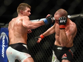 Stephen Thompson swigs at Rory MacDonald in the welterweight main event during UFC Fight Night. Darren Brown/Postmedia