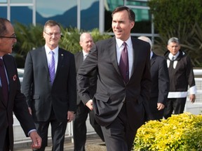 Federal Finance Minister Bill Morneau, right, speaks with Alberta Finance Minister Joe Ceci during a meeting of finance ministers in Vancouver, Monday, June 20, 2016. THE CANADIAN PRESS/Jonathan Hayward