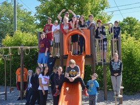 Students from the final graduating Grade 8 class at First Avenue Public School pose for a photo on the school's climber in Kingston. (Lindsay Dowker/Postmedia Network