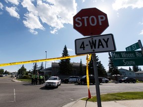 A four way stop sign is seen as Edmonton Police Service officers investigate after a male pedestrian was killed in a hit and run at 48 Street and Mill Woods Road South in Edmonton, Alta., on Monday June 20, 2016. A driver was arrested by police a short distance away. It is the second fatal crash in the area since April, locals said. Photo by Ian Kucerak