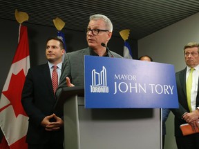 Liberal MP Adam Vaughan (podium), MP Marco Mendicino (L) and Toronto Mayor John Tory announce a job creation summer program for disadvantaged youth in the northwest sector of the city to help combat gun violence on Monday June 20, 2016. (Jack Boland/Toronto Sun)