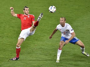 Wales forward Gareth Bale vies for the ball against Russia's midfielder Denis Glushakov during the Euro 2016 Group B match between Russia and Wales at the Stadium Municipal in Toulouse on June 20, 2016. (AFP PHOTO/Pascal PAVANI)