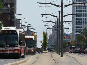 TTC busses replace the street cars along St. Clair Ave. W. near Bathurst St. in Toronto on Monday June 20, 2016. (Dave Abel/Toronto Sun)