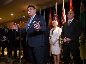 Ontario Finance Minister Charles Sousa, left, speaks as New Brunswick Finance Minister Cathy Rogers, second right, and B.C. Finance Minister Mike de Jong, right, listen during a news conference after reaching a deal to expand the Canada Pension Plan, in Vancouver, B.C., on Monday June 20, 2016. THE CANADIAN PRESS/Darryl Dyck