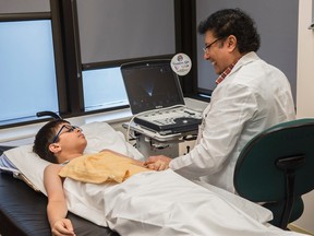 Sonographer Samad Khan examines Eduardo Esis-Castro, 13. The pediatric cardiac clinic at the Stollery Children’s Hospital unveiled their new portable cardiovascular ultrasound system which can be taken to the patient for cardiac evaluation. Shaughn Butts / POSTMEDIA NEWS NETWORK