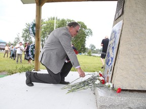 Richard Paquin places a carnation at the cenotaph during  the Sudbury Mine Mill & Smelter  Workers' Union Local 598/Unifor 32rd annual Worker's Memorial Day Service in Sudbury, Ont. on Monday June 20, 2016. The day is a memorial for  workers killed on June 20, 1984. after a tragic fall of ground occurred in the Falconbridge Mine at 10:12 a.m., taking the lives of  Sulo Korpela, Richard Chenier, Daniel Lavallee and Wayne St. Michel. Gino Donato/Sudbury Star/Postmedia Network