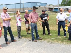 BRUCE BELL/STAFF REPORTER
B.J. Prince (cowboy hat) of Rawhide Rodeo Company looks over the site at the Picton Fairgrounds with municipal staff and members of the Prince Edward Agricultural Society. The groups will host the inaugural County Championship Rodeo July 23 - 24 with more than 200 athletes expected to compete.