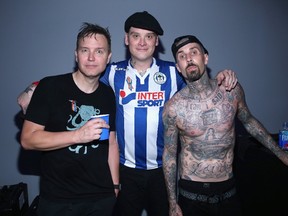 (L-R) Musicians Mark Hoppus, Matt Skiba and Travis Barker of Blink-182 backstage as Bethesda Softworks Jonathan Leibson/Getty Images for Bethesda Softworks LLC/AFP