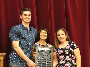 Jack Goerke and Megan Brown receive the Sue Fahey Trojan Excellence Award for outstanding contribution to Moira Trojans athletics. Sue Fahey, former longtime teacher-coach at MSS, presents the award named in her honour. (Submitted photo)