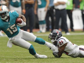 Davone Bess of the Miami Dolphins is tackled by Brice McCain of the Houston Texans during the season opener at Reliant Stadium on September 9, 2012 in Houston. (Bob Levey/Getty Images/AFP)