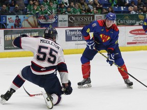 Keaton Middleton, left, of the Saginaw Spirit, attempts to block the shot of Dmitry Sokolov, of the Sudbury Wolves, during OHL action at the Sudbury Community Arena in Sudbury, Ont. on Friday February 12, 2016. John Lappa/The Sudbury Star/Postmedia Network