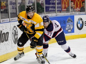 Kingston Frontenacs defenceman Jacob Paquette beats Jesse Barwell of the Saginaw Spirit to the puck behind the Frontenacs net during Ontario Hockey League action at the Rogers K-Rock Centre on Jan. 22. (Julia McKay/The Whig-Standard)