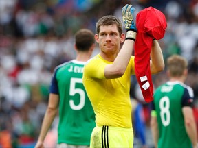 Northern Ireland goalkeeper Michael McGovern applauds at the end of the Euro 2016 match against Germany at the Parc des Princes stadium in Paris Tuesday, June 21, 2016. (AP Photo/Francois Mori)